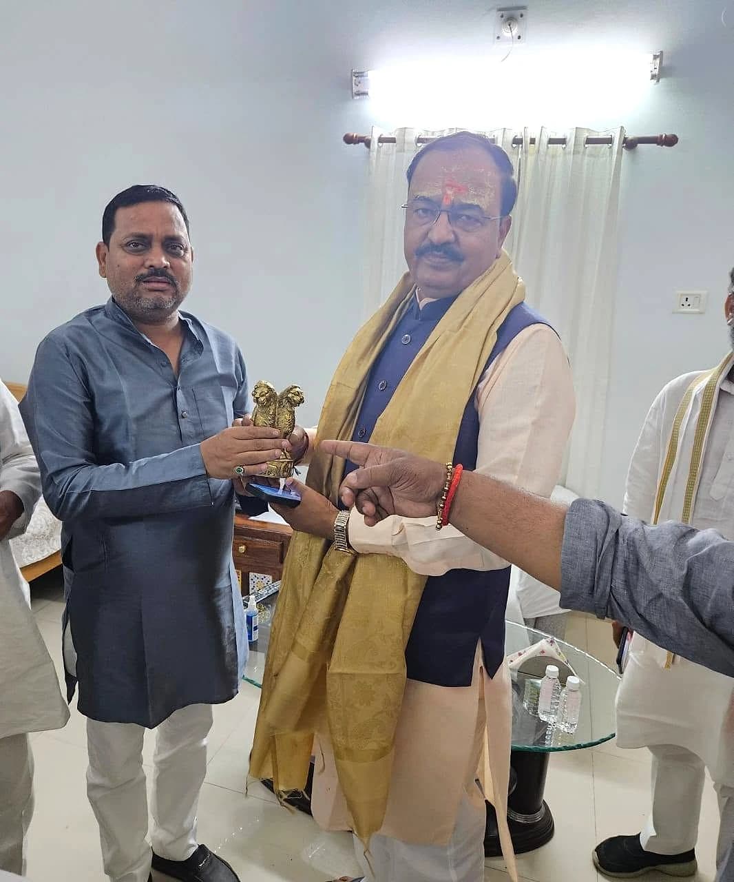 Deputy Chief Minister Shri Keshav Prasad Maurya, wearing a golden shawl, receiving a memento during the meeting